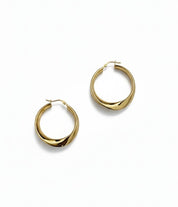 Gold hoop earrings on a white background