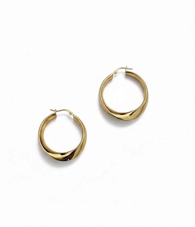 Gold hoop earrings on a white background